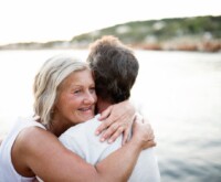 Senior lady hugging her partner